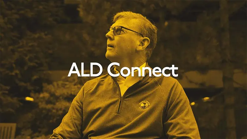Tim seated in a living room, from the ALD Connect patient story
